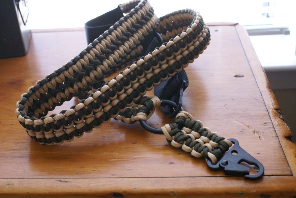 Convertible single point paracord rifle sling. Primary color tan. Secondary color od green. Double cobra weave. HK hooks.