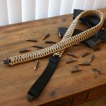 Two point paracord gun sling. Primary color tan. Secondary color black. King cobra weave. TOC quick disconnect swivels.