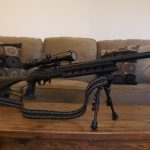 Two point paracord rifle sling on a rifle. Primary color camo. Secondary color black. Double cobra weave.