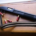 Two point paracord shotgun sling. Primary color black. Secondary color tan. Extra wide double cobra weave.