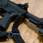 Convertible single point paracord sling triglide. Double cobra weave in black. Push button quick release swivels.