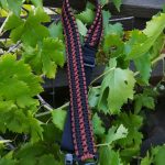 Two point paracord gun sling. Primary color black. Secondary color rust brown. Double cobra weave. GrovTec quick disconnect swivels.