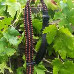 Convertible single point paracord rifle sling. Primary color black. Secondary color rust brown. Extra wide double cobra weave. Push button quick release swivels.