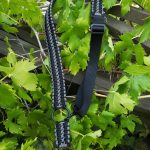 Convertible single point paracord rifle sling. Primary color black. Secondary color grey. Double Cobra weave. Standard hooks.