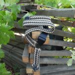 Single point paracord rifle sling. Primary color Tan. Secondary color od green. Double cobra weave. Push button quick release swivel.