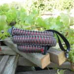 Two point paracord gun sling. Primary color grey. Secondary color red. King cobra weave. TOC quick disconnect swivels.