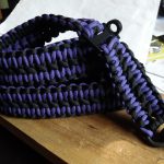 Tavor convertible single point paracord gun sling. Primary color purple. Secondary color black. Double Cobra weave. Push button quick release swivels.