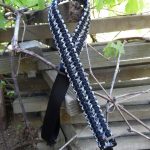 Two point paracord gun sling. Primary color black. Secondary color urban camo. Double cobra weave. GrovTec quick disconnect swivels.