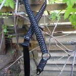 Convertible single point paracord rifle sling. Primary color black. Secondary color urban camo. King cobra weave. HK hooks.
