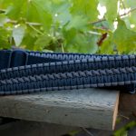 Two point paracord gun sling. Primary color black. Secondary color grey. Extra wide double cobra weave. TOC quick disconnect swivels.