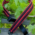 Two point paracord rifle sling. Primary color black. Secondary color red. Extra wide double cobra weave. Push button quick release swivels.
