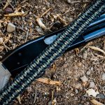 Two point paracord shotgun sling on a shotgun. Primary color woodland camo. Secondary color black. Double cobra weave.